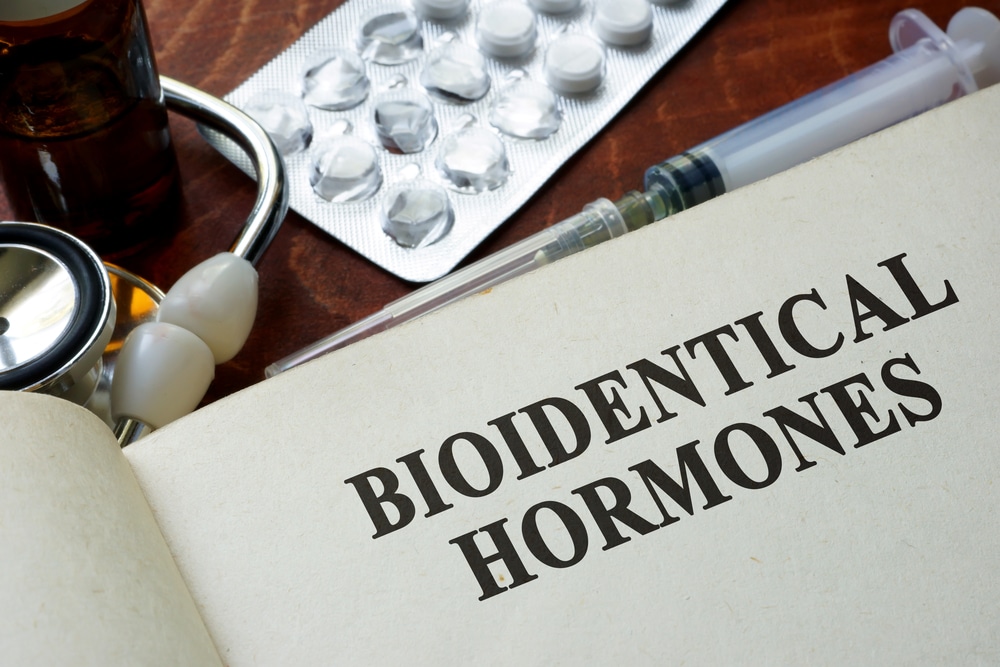 Book with words bioidentical hormones on a table.