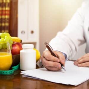 Nutritionist writing diet plan, dietician consultation, health