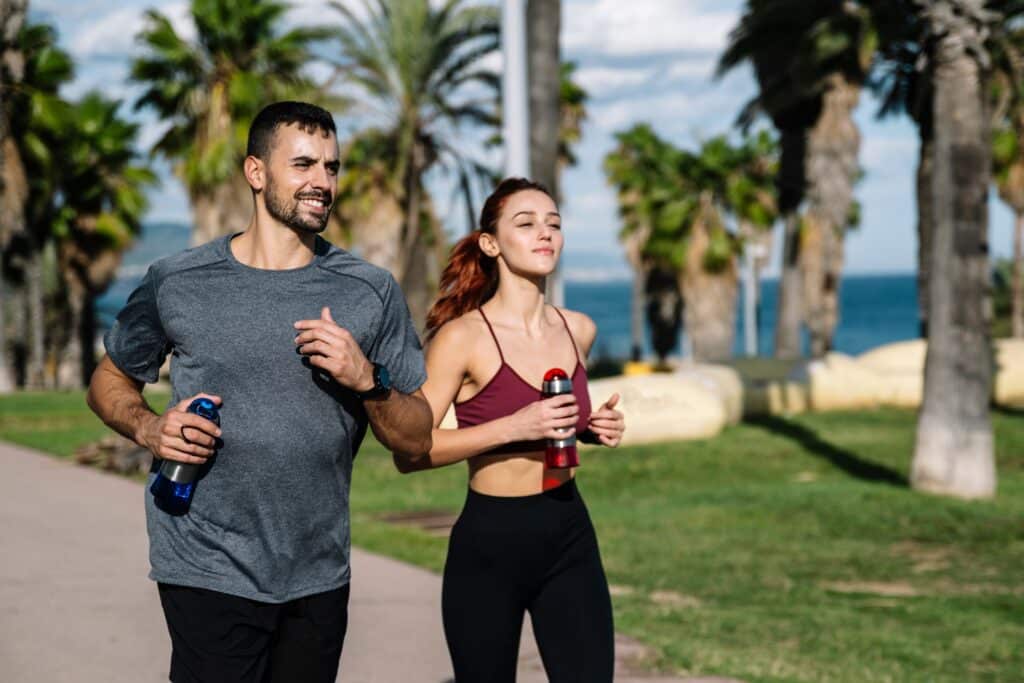 Fit couple running outside in tropical location
