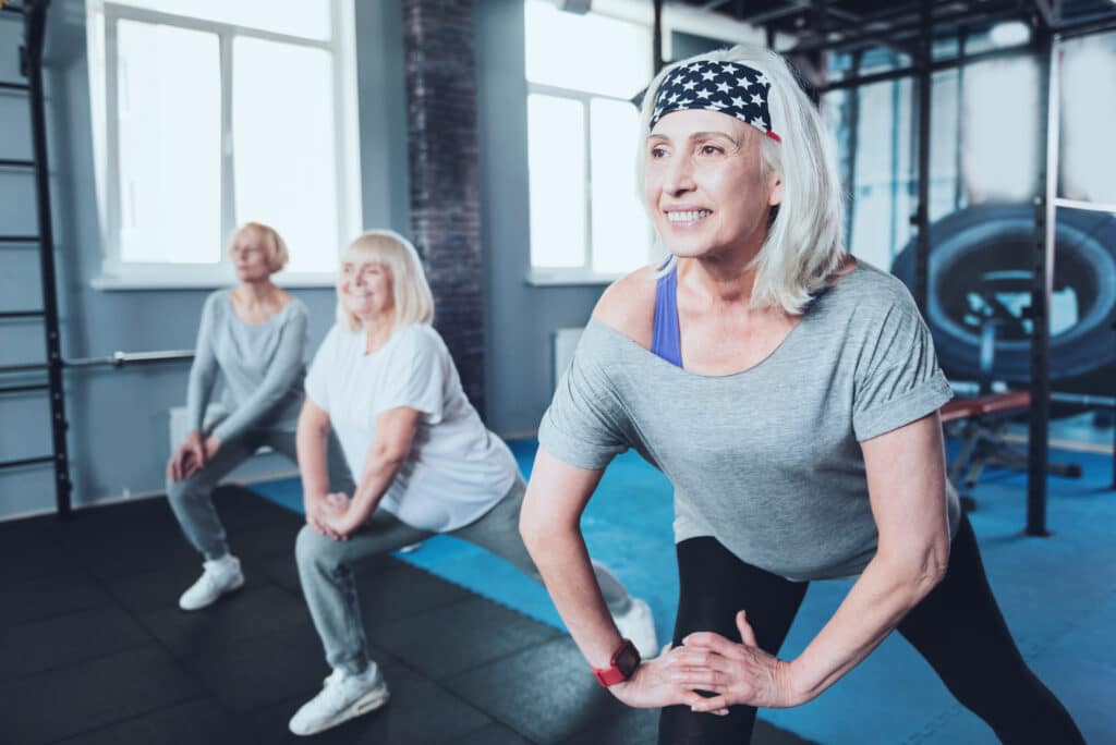 Three older woman exercising at the gym to maintain muscle mass