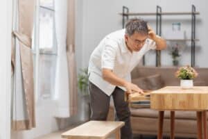 Man searching desk after he forgot where he put something due to brain fog and hormonal imbalances.