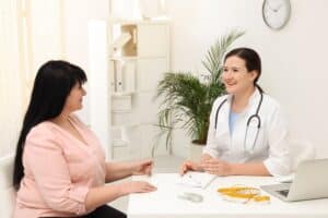 Doctor meeting with overweight women to discuss insulin resistance and BHRT.