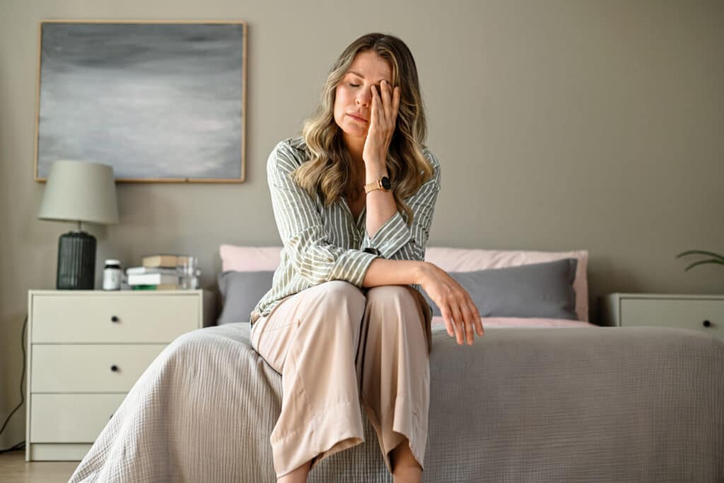 Woman experiencing fatigue and stress, representing symptoms that may be related to hormonal imbalance.