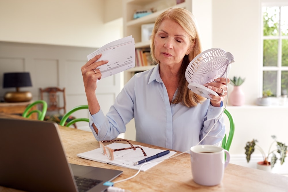 Woman experiencing hot flashes and menopause symptoms before starting hormone replacement therapy